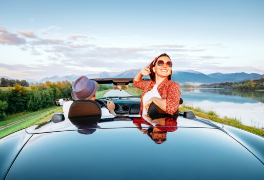 Couple in love ride in cabriolet on the picturesque mountain road